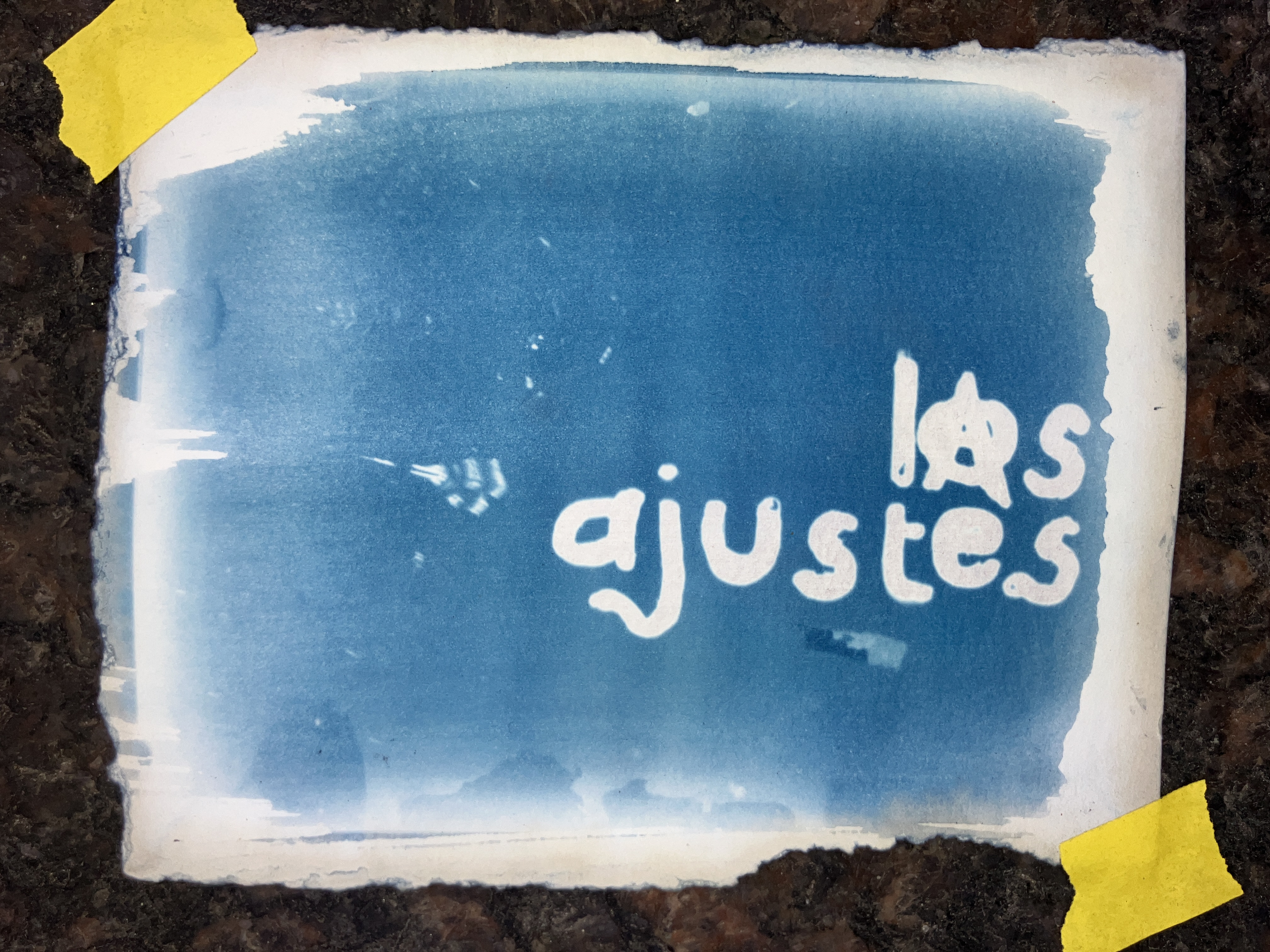 a title page in cyanotype. The Empire State Building glows in the darkness below